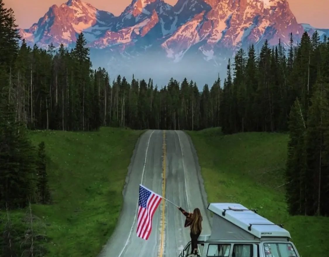 American girl holding a flag in nature