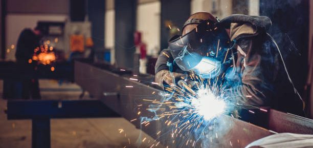 American worker welding during his shift. 